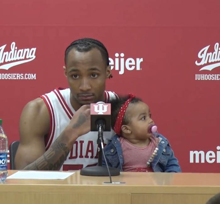 Indiana sophomore guard Tamar Bates answers questions at the postgame press conference with his daughter Leilani, who won the halftime baby race on Sunday at Simon Skjodt Assembly Hall in Bloomington, Ind.